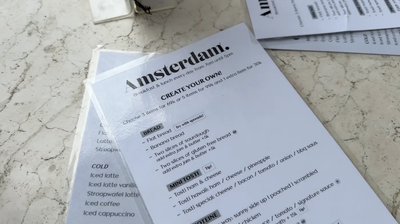 A menu titled Create your own at Amsterdam on a marble table