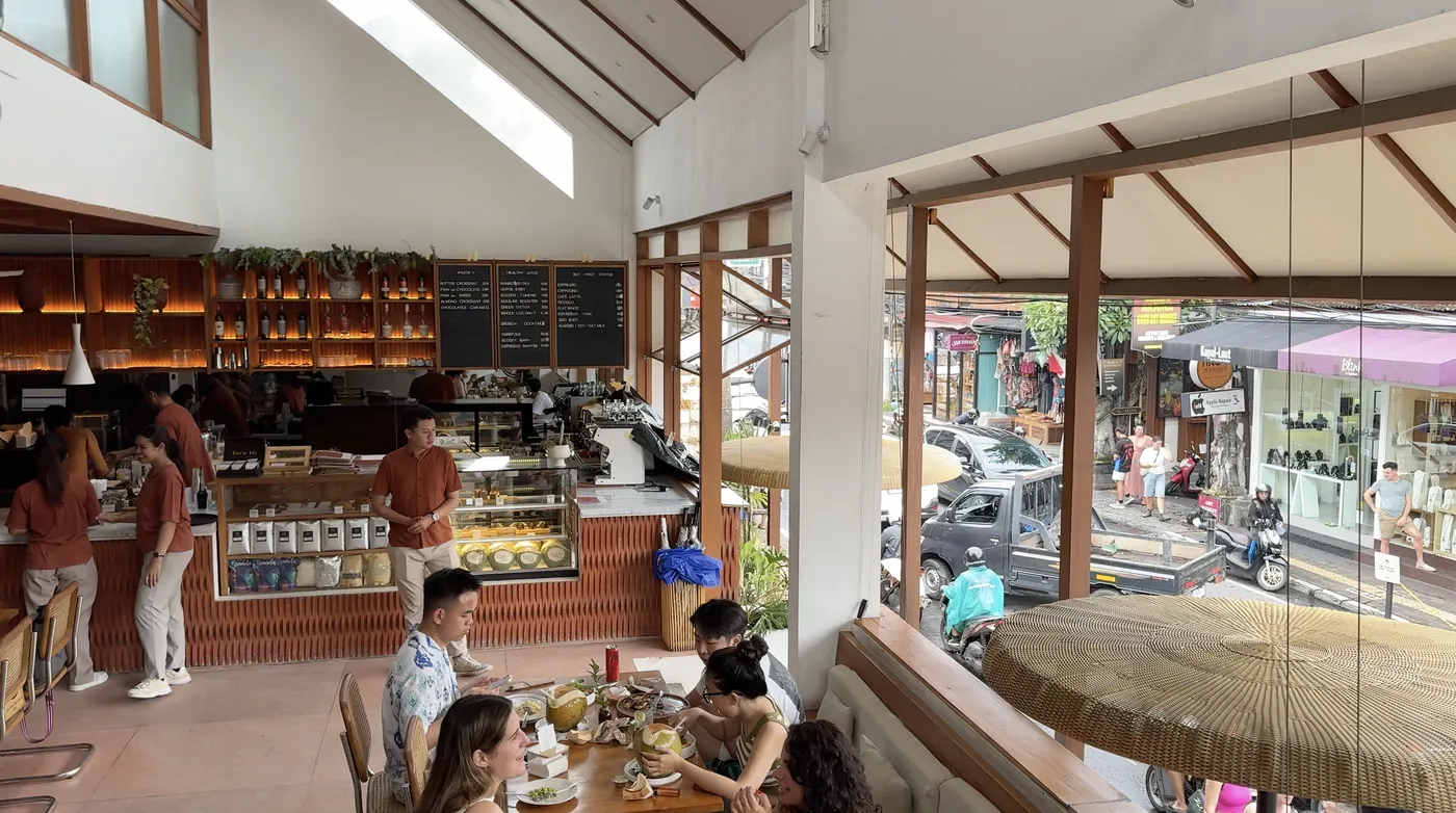 The bright high room of Sala Bistro with a long bar and guests at tables